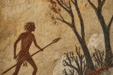 The hunter goes hunting into the wood with a spear